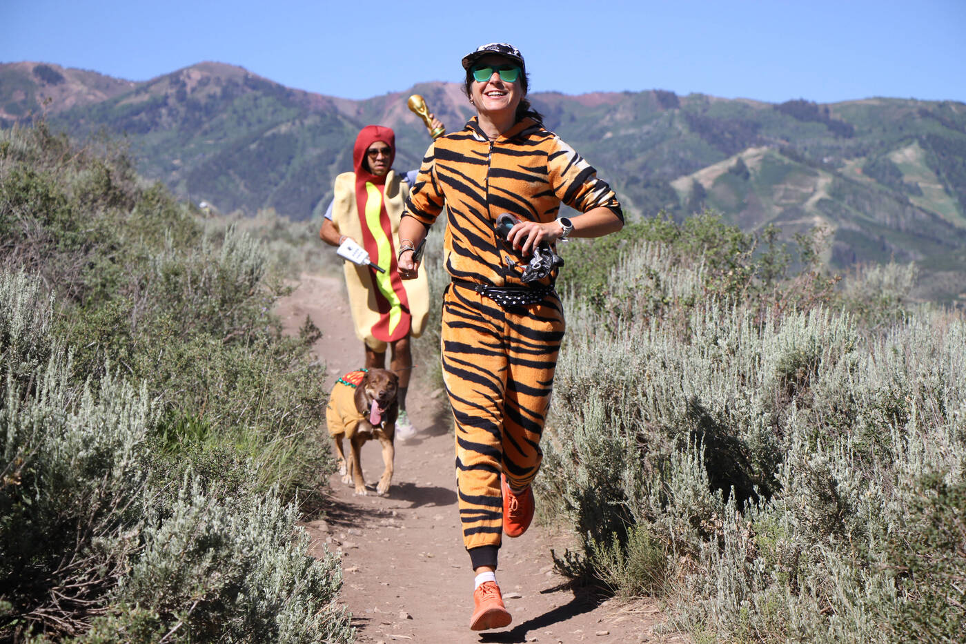 Susie Bousquet running a desert trail in a tiger costume