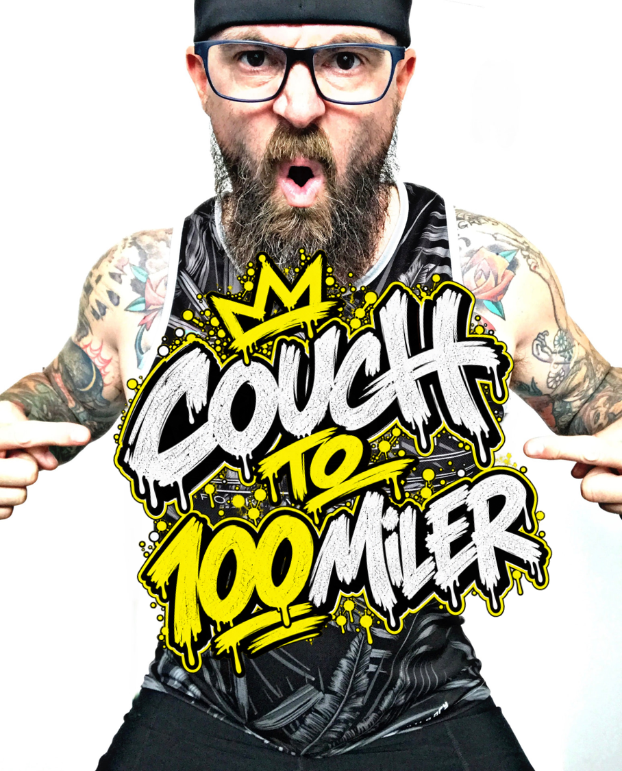 Scott Ward pointing at the Couch to 100 Miler graphic on his tank top
